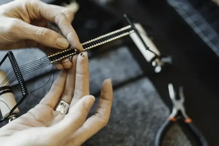 Student filing a sterling silver ring at the Bintang Kuta Jewelry Workshop bench in Legian